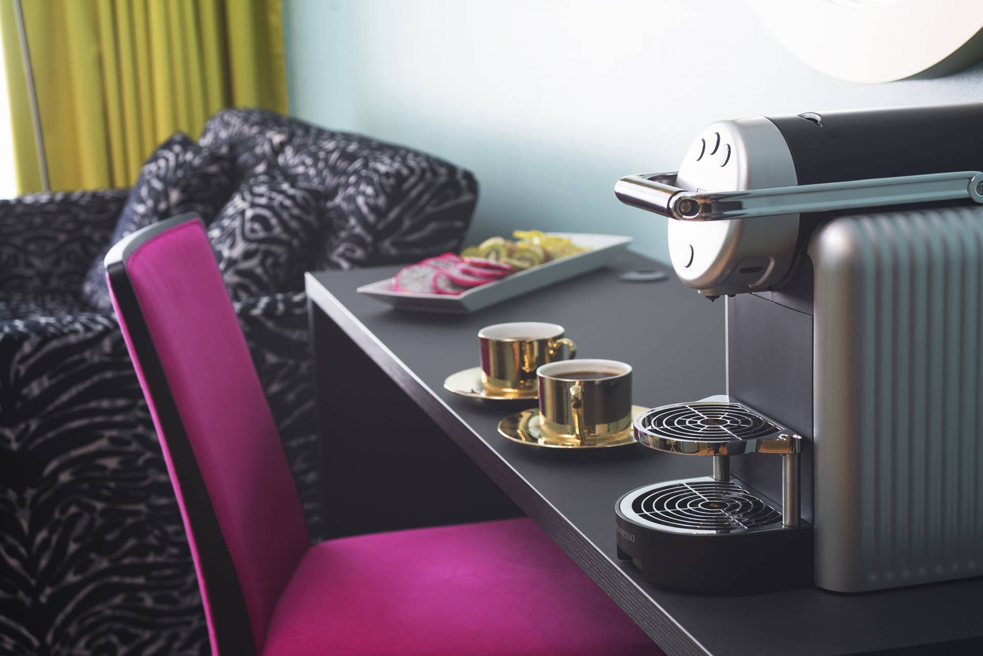 Two brass coffee cups and a capsule machine in a room at the Thon Hotel Terminus in Oslo. Photo