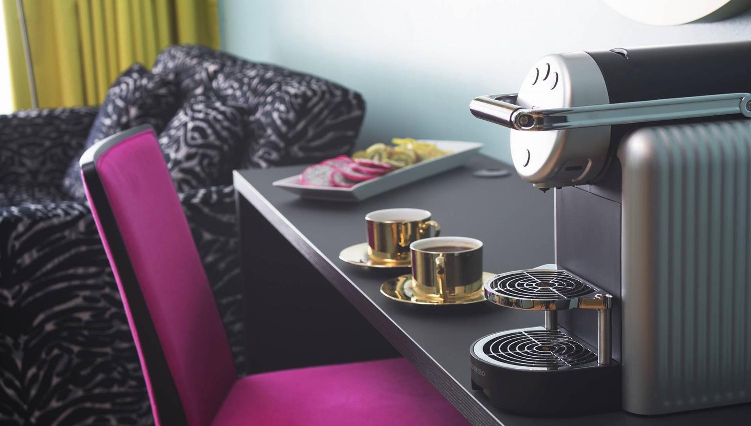 Two brass coffee cups and a capsule machine in a room at the Thon Hotel Terminus in Oslo. Photo