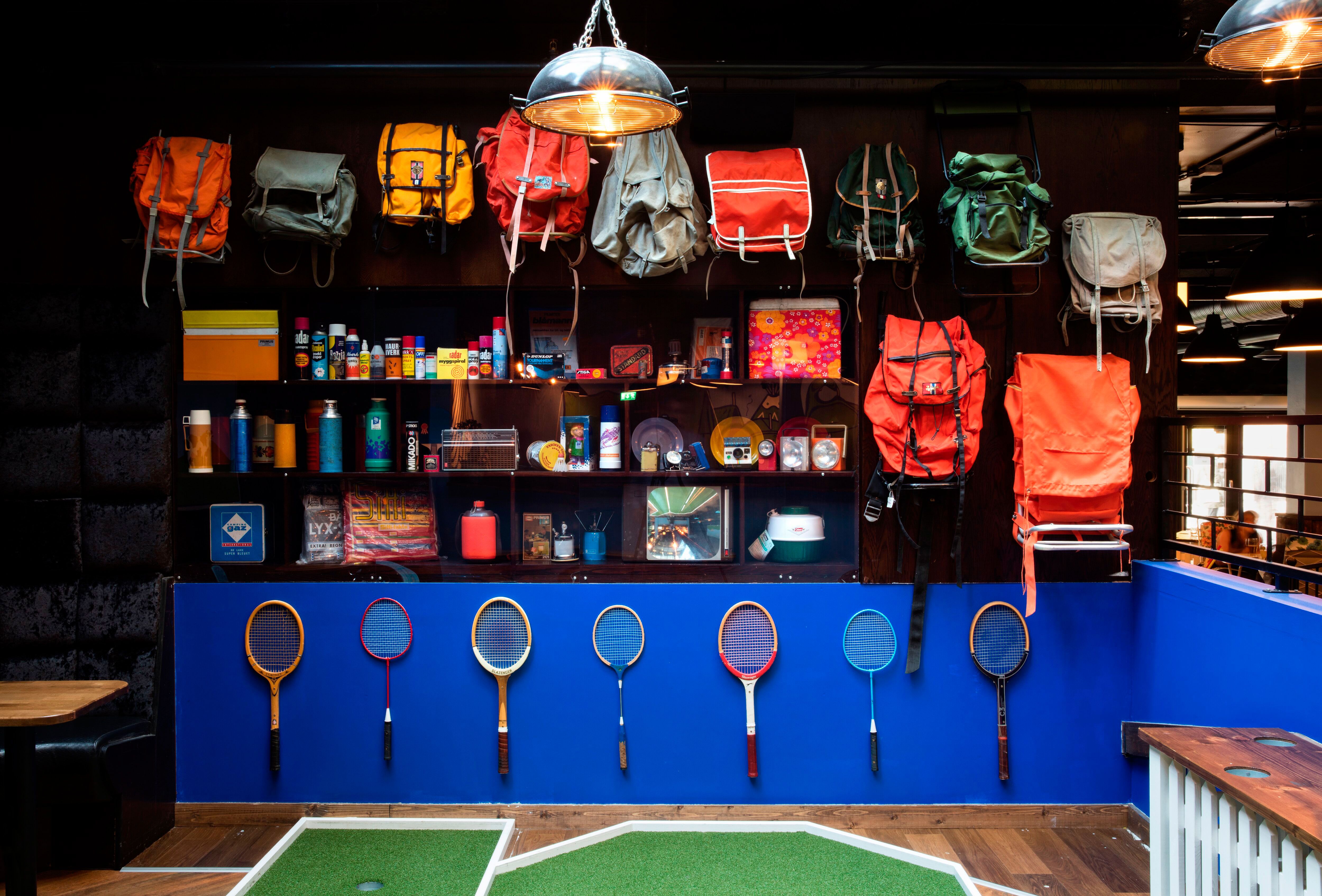 Details: various backpacks on the wall, tennis equipment and miscellaneous