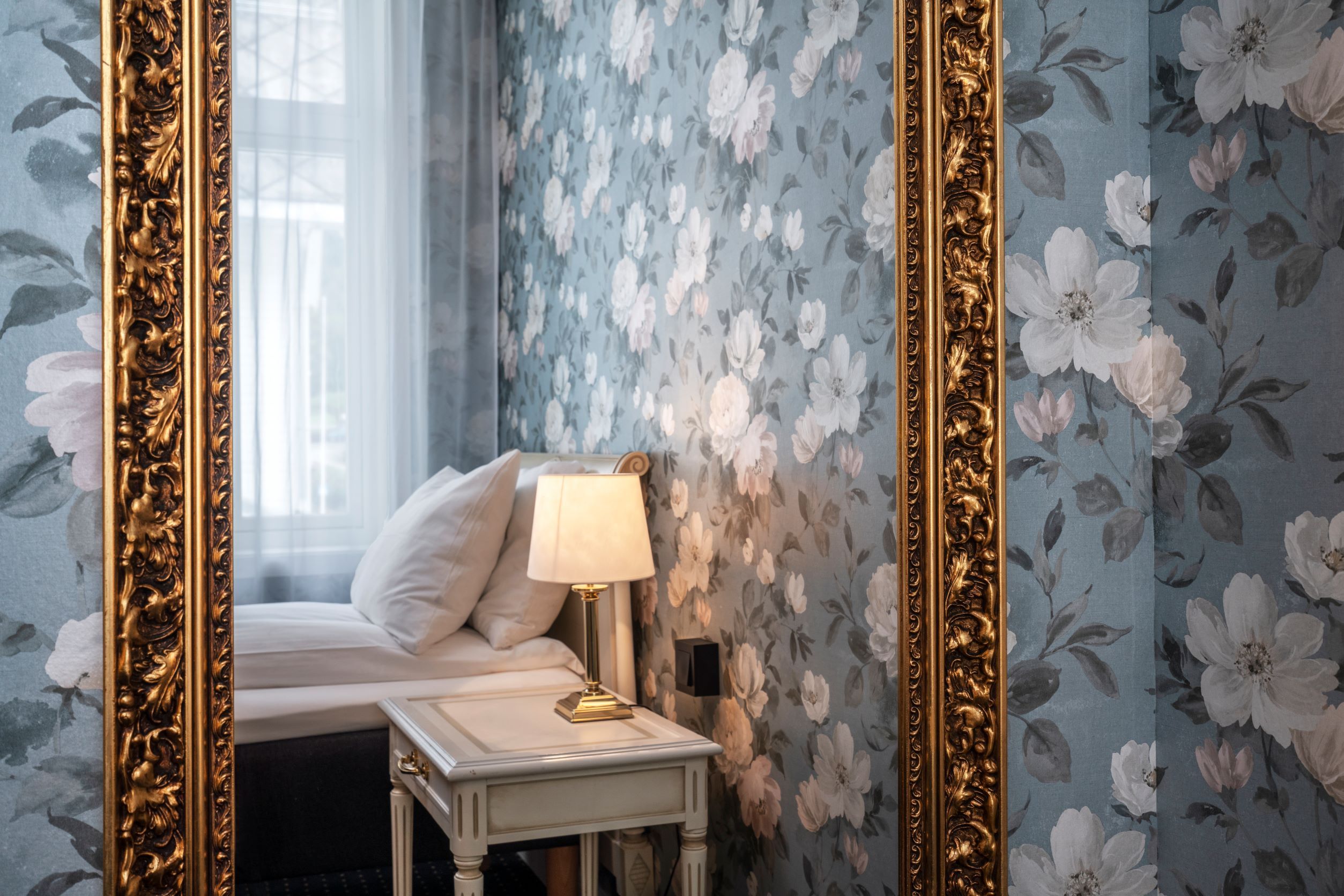 Stilige detaljar på Thon Hotel Sandven – klassisk spegel med gullramme reflekterer den elegante innreiinga.