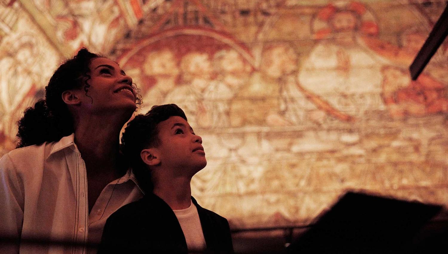 Woman and child looking at the roof from Ål stave church