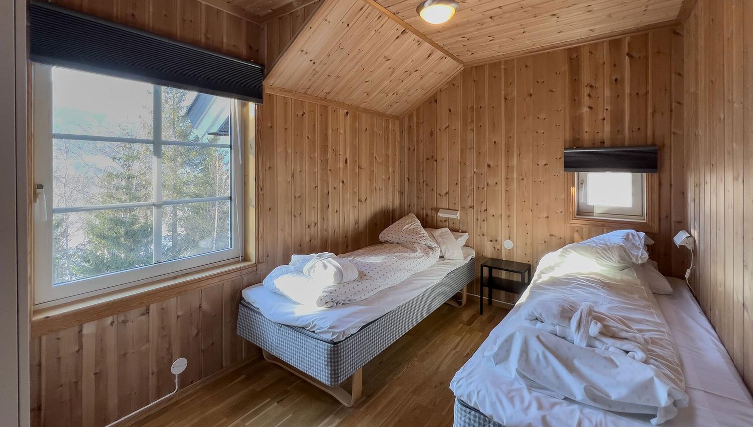 A room with two beds and a window.