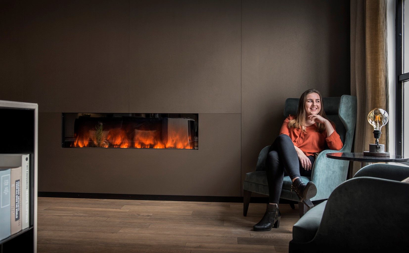 Lady sitting by the fireplace