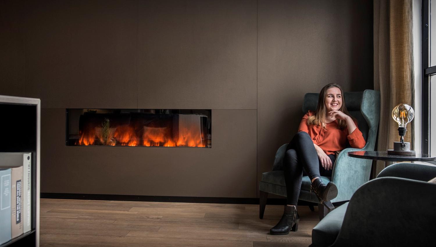 Lady sitting by the fireplace