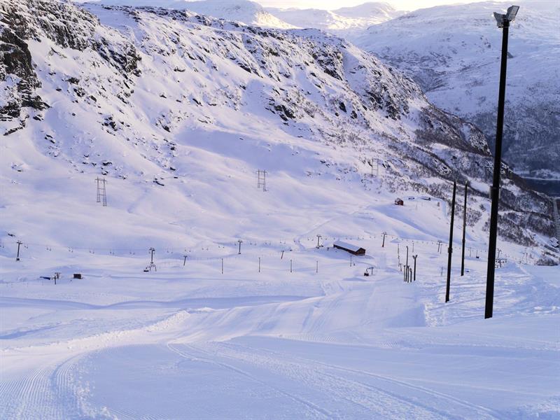 Freshly groomed slopes at Røldal Ski Resort surrounded by steep mountain scenery.