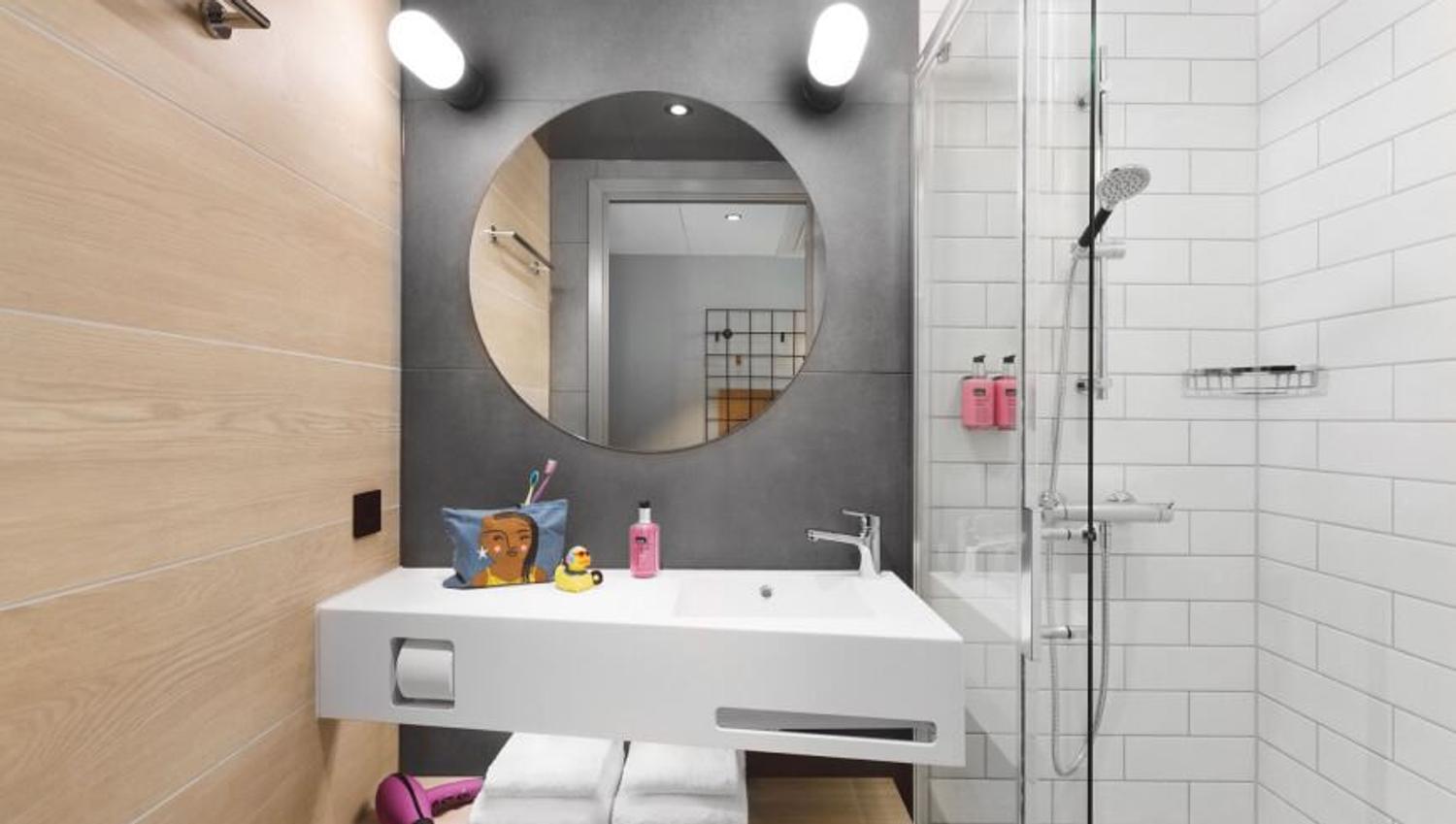 Sink, mirror and shower in the bathroom.