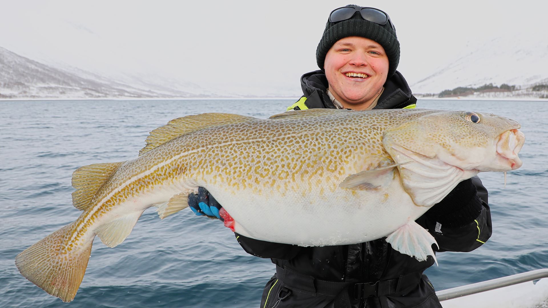 A guest holding a fish