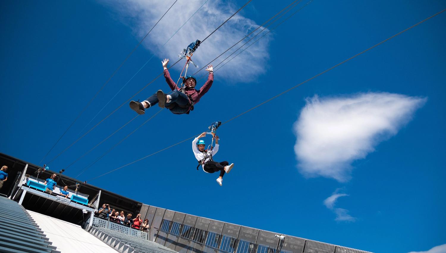 To personer som zipliner nedover Holmenkollbakken.