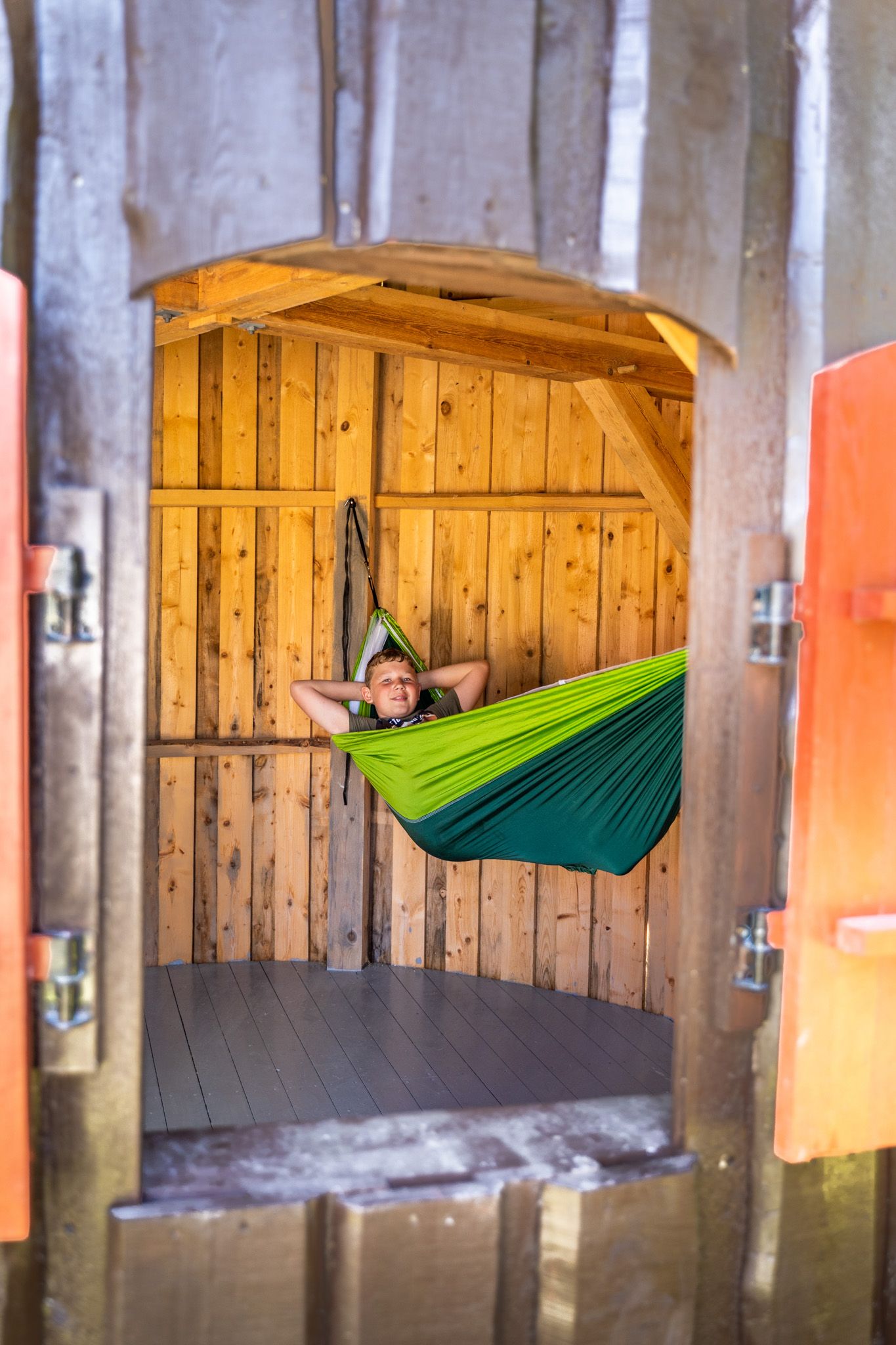 gutt i hengekøye i hytte