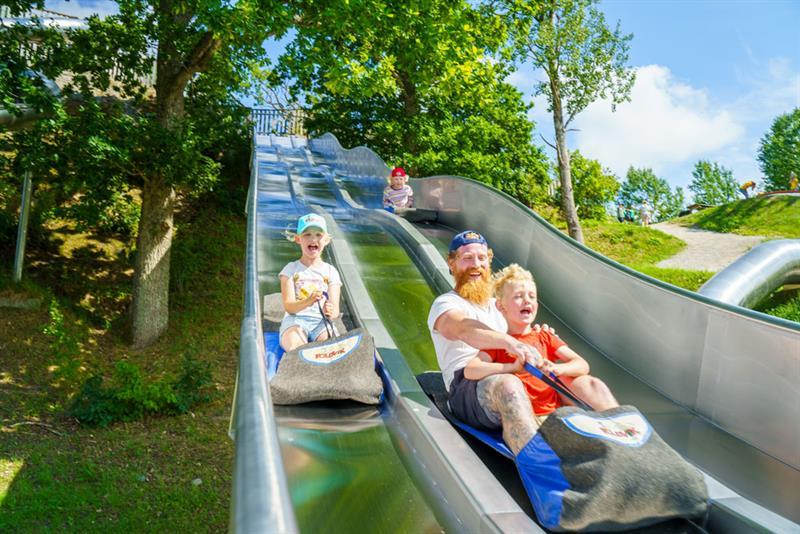 children and adults on a slide in Foldvik family park