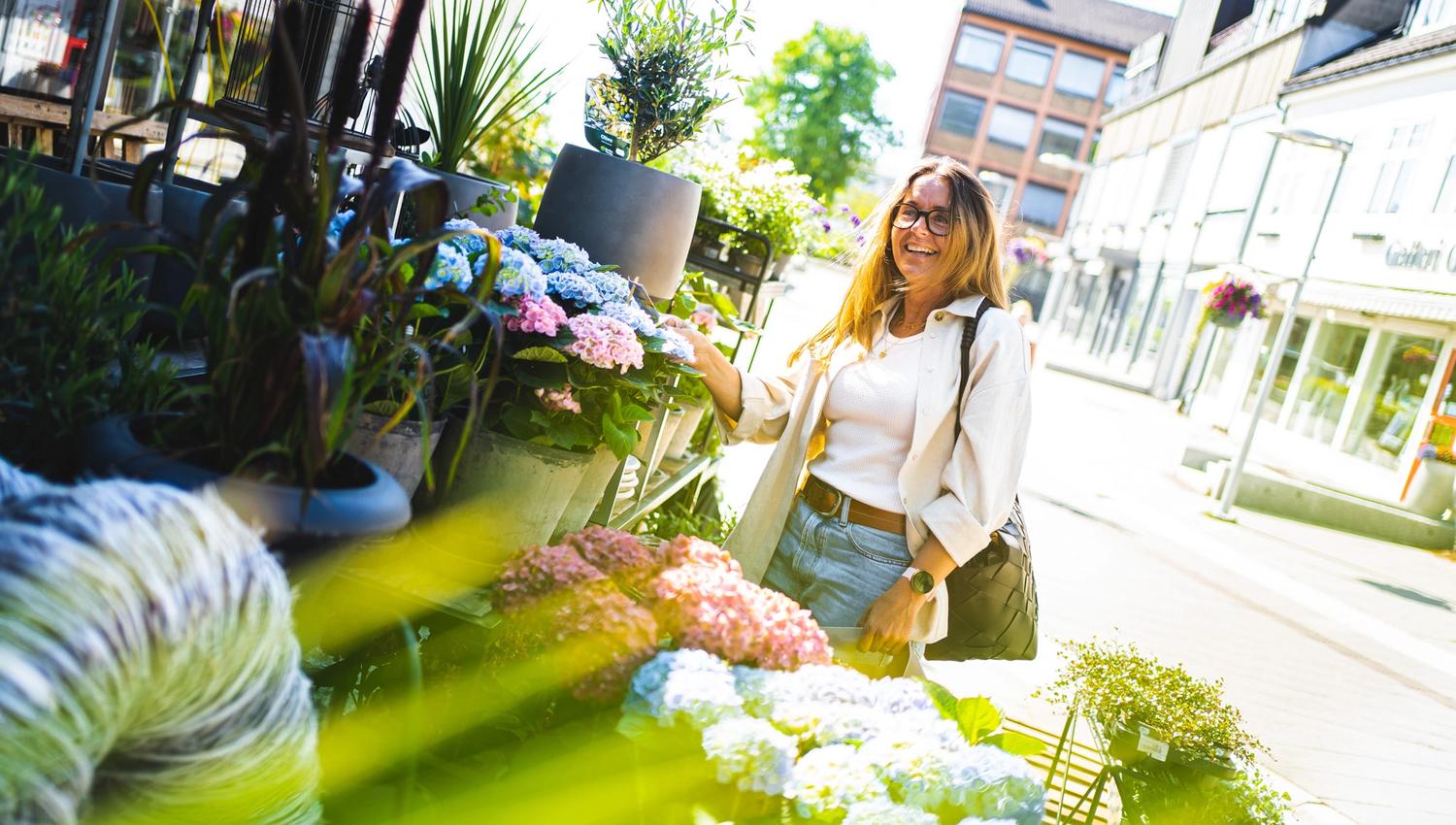 woman looking at flowers