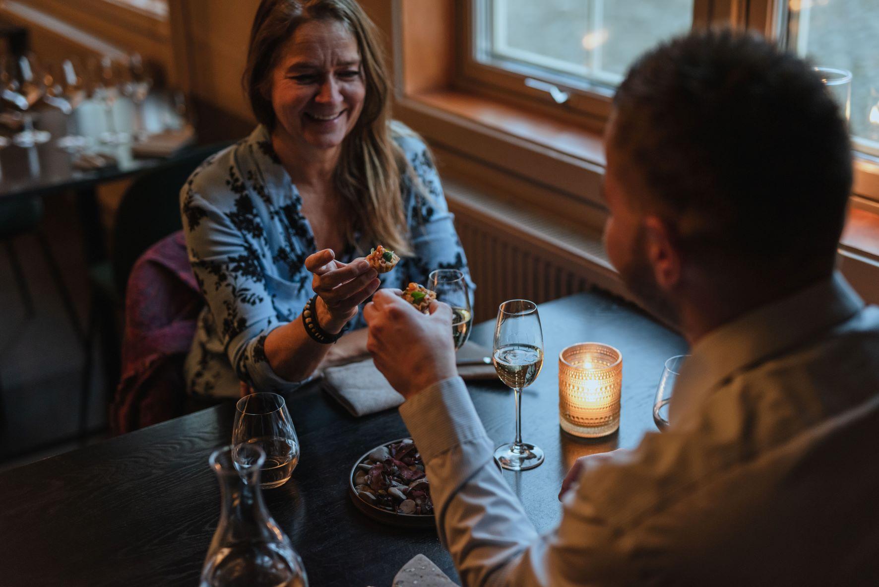 Two persons eating together at a table