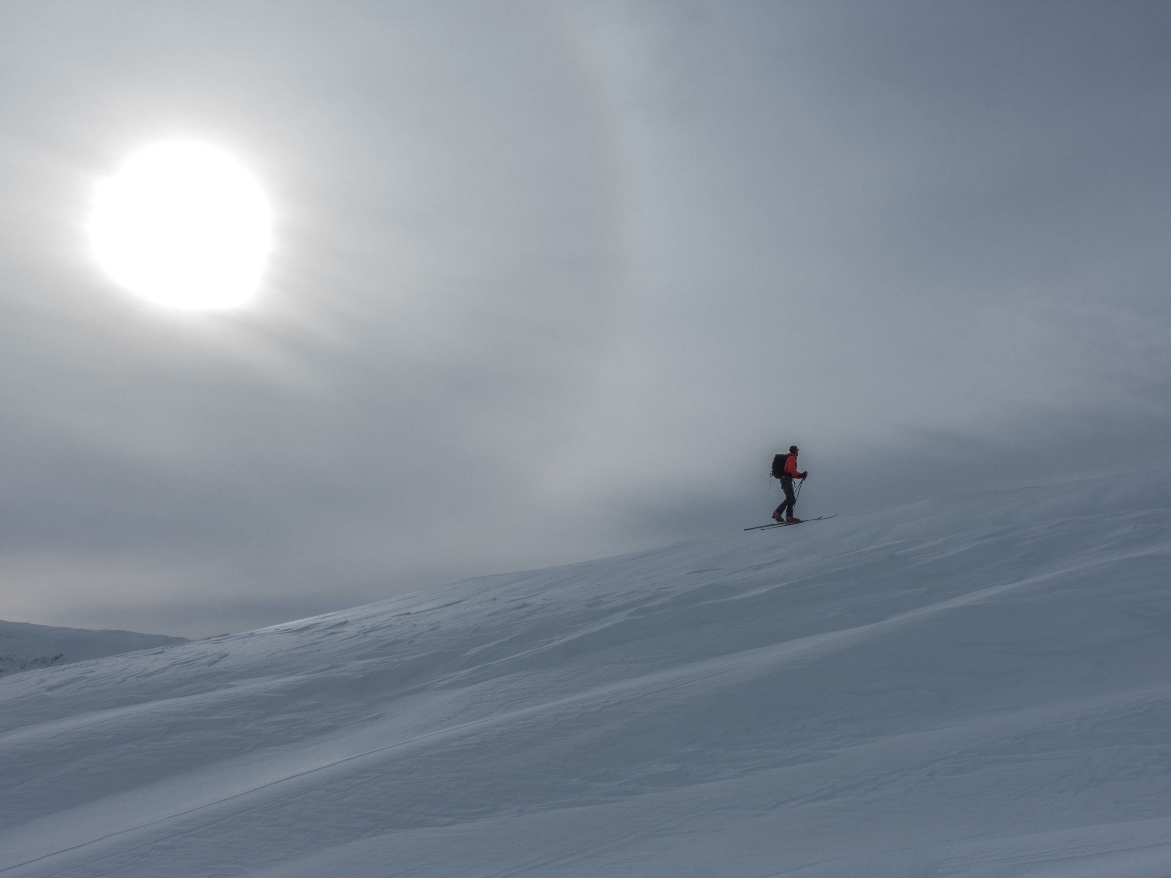 Going skiing with sun in the background