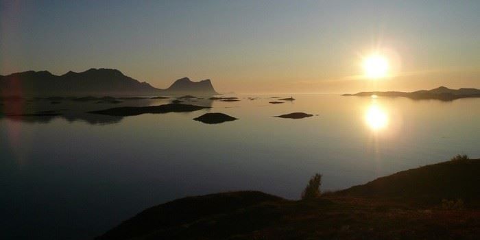 midnattssolen skinner på fjorden