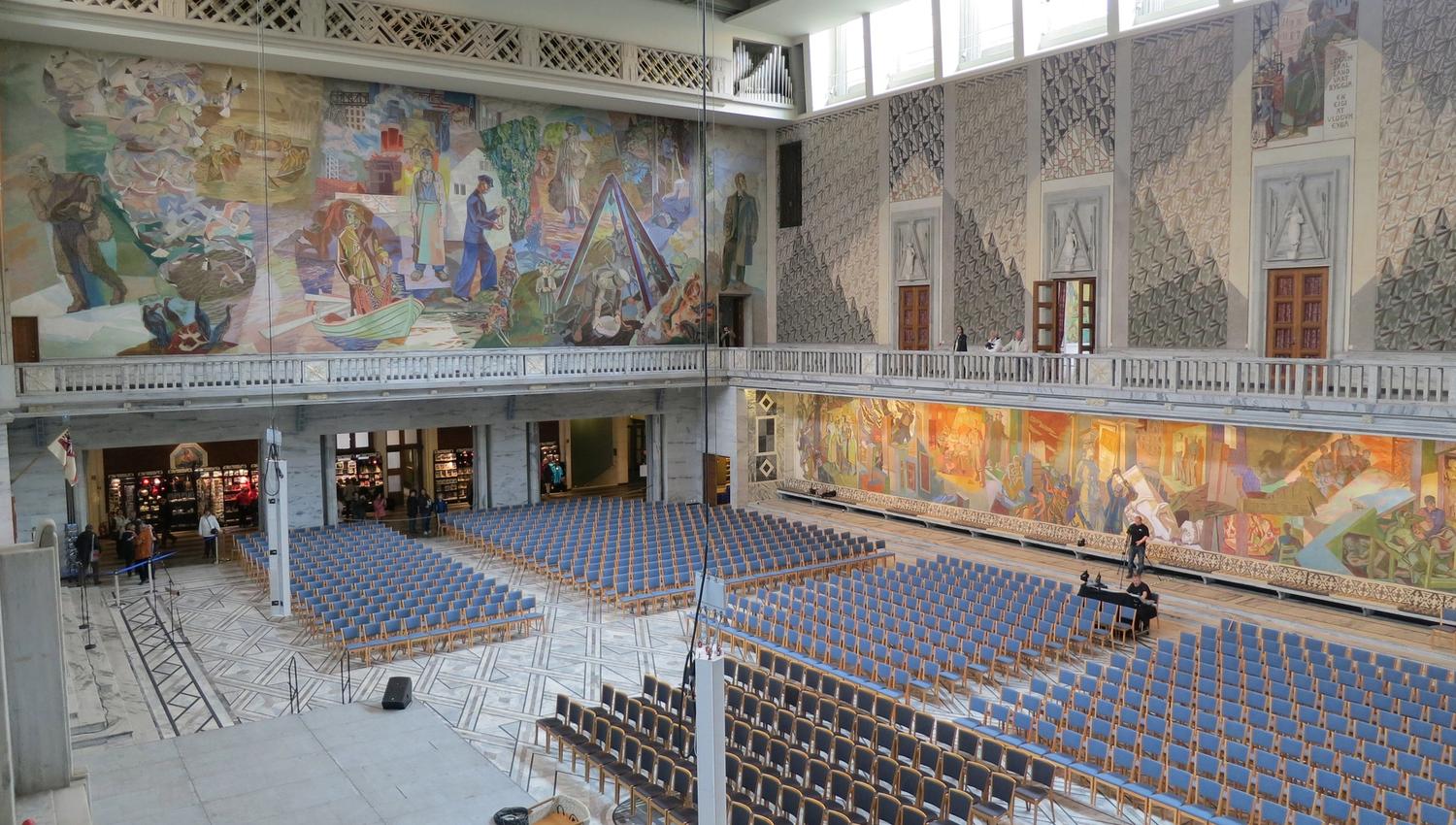 oslo city hall prepared for an event with many chairs facing a podium