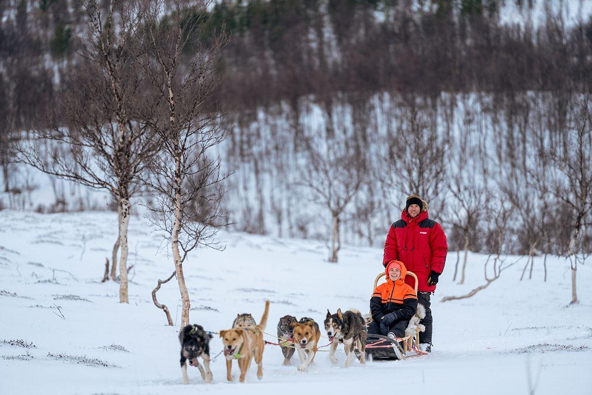 Two guests drive the dog sled