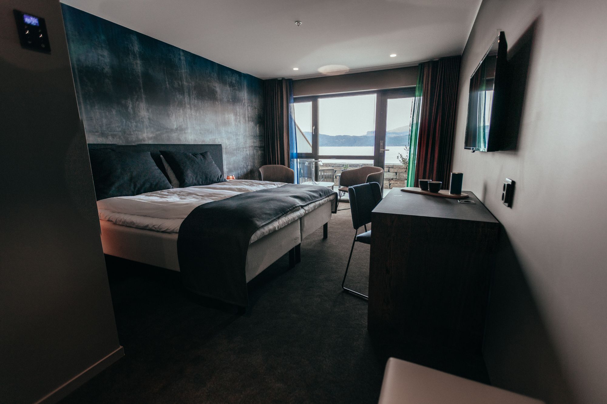 Modern and stylish hotel room at Hardanger House with a view of the Hardangerfjord.