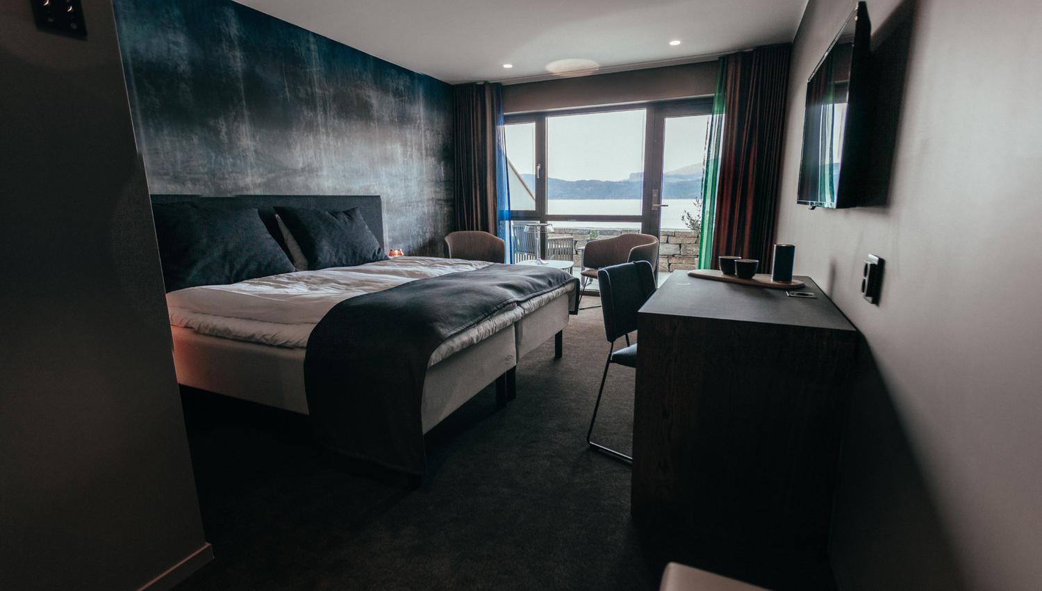 Modern and stylish hotel room at Hardanger House with a view of the Hardangerfjord.
