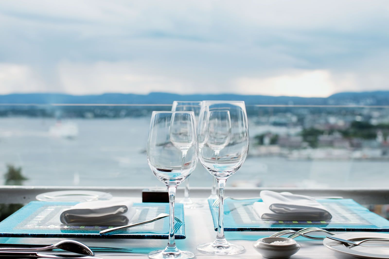 A table with a view of the city and the fjord.