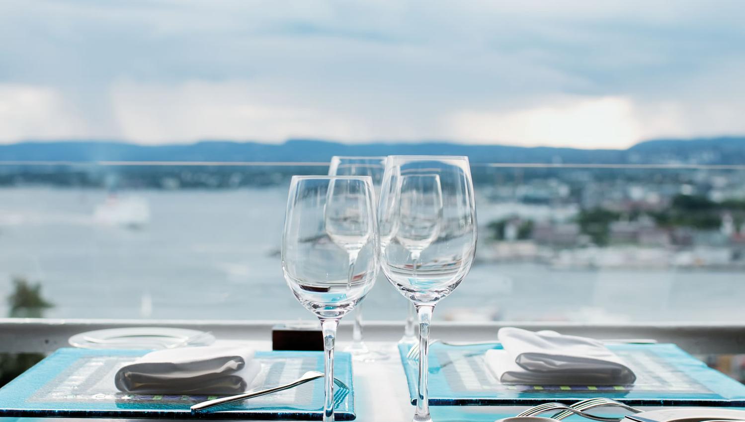 A table with a view of the city and the fjord.