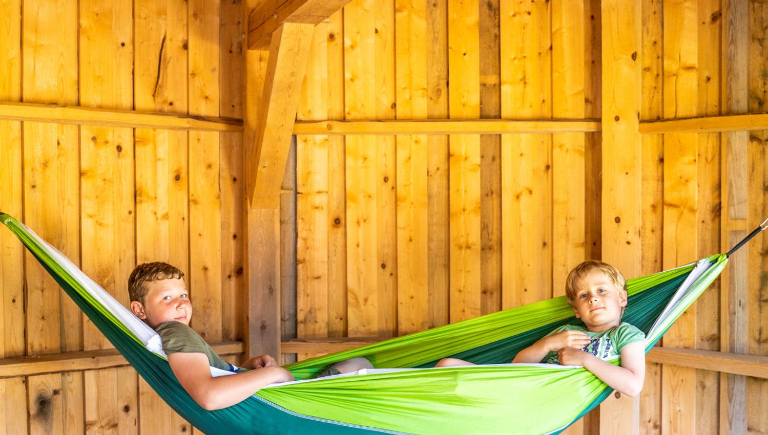 gutter i hengekøye i en hytte