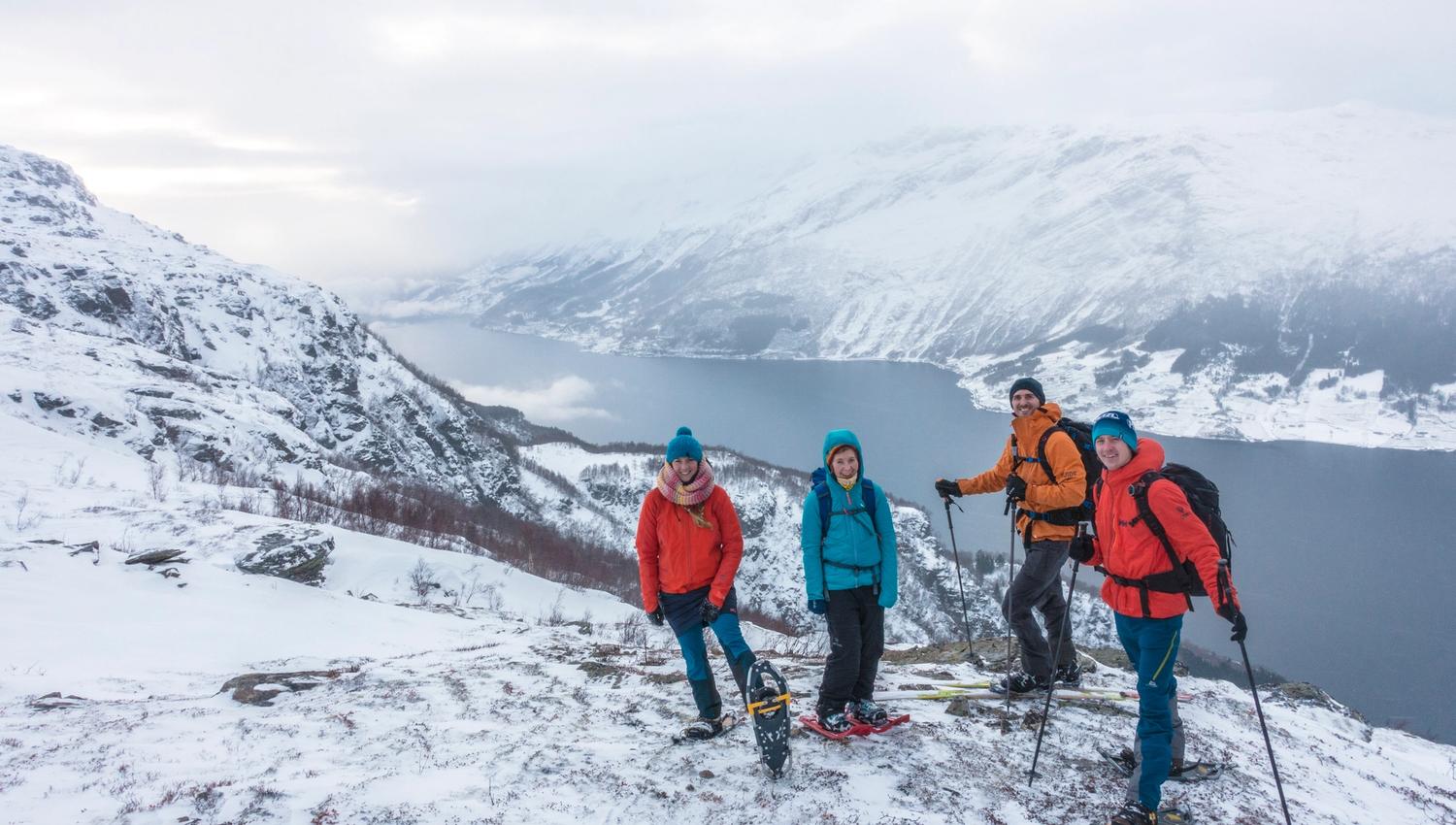 Friends on a snowshoe tour taking a break with a view of the Hardangerfjord.