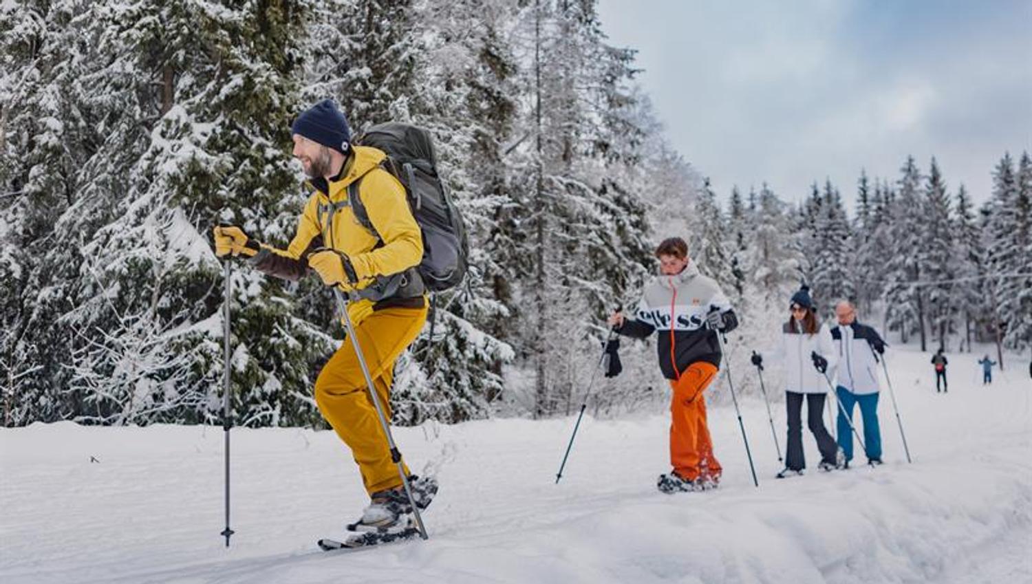 A group snowshoeing through the snow