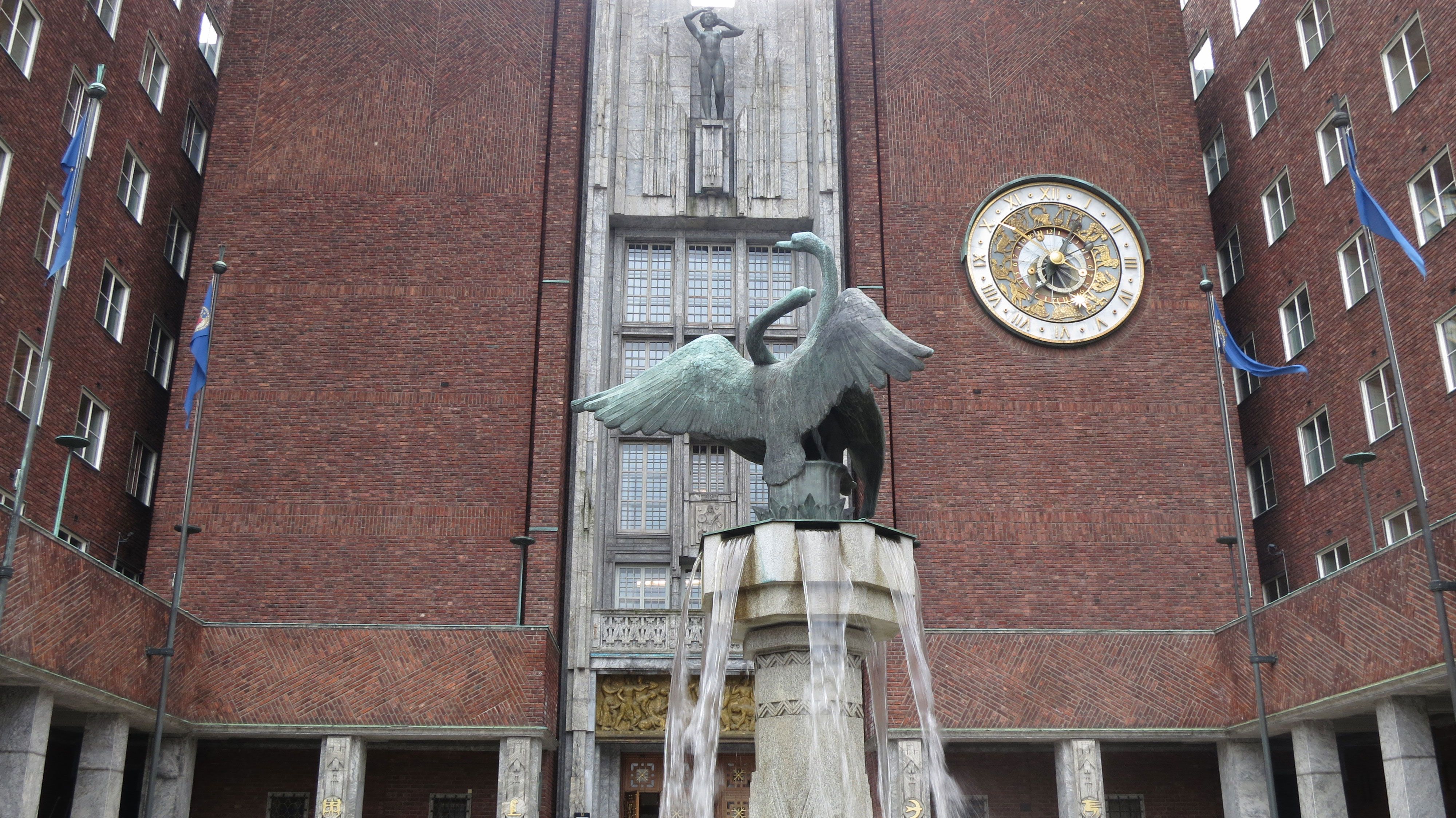 statue on the fountain in front of the main entrance of oslo city hall