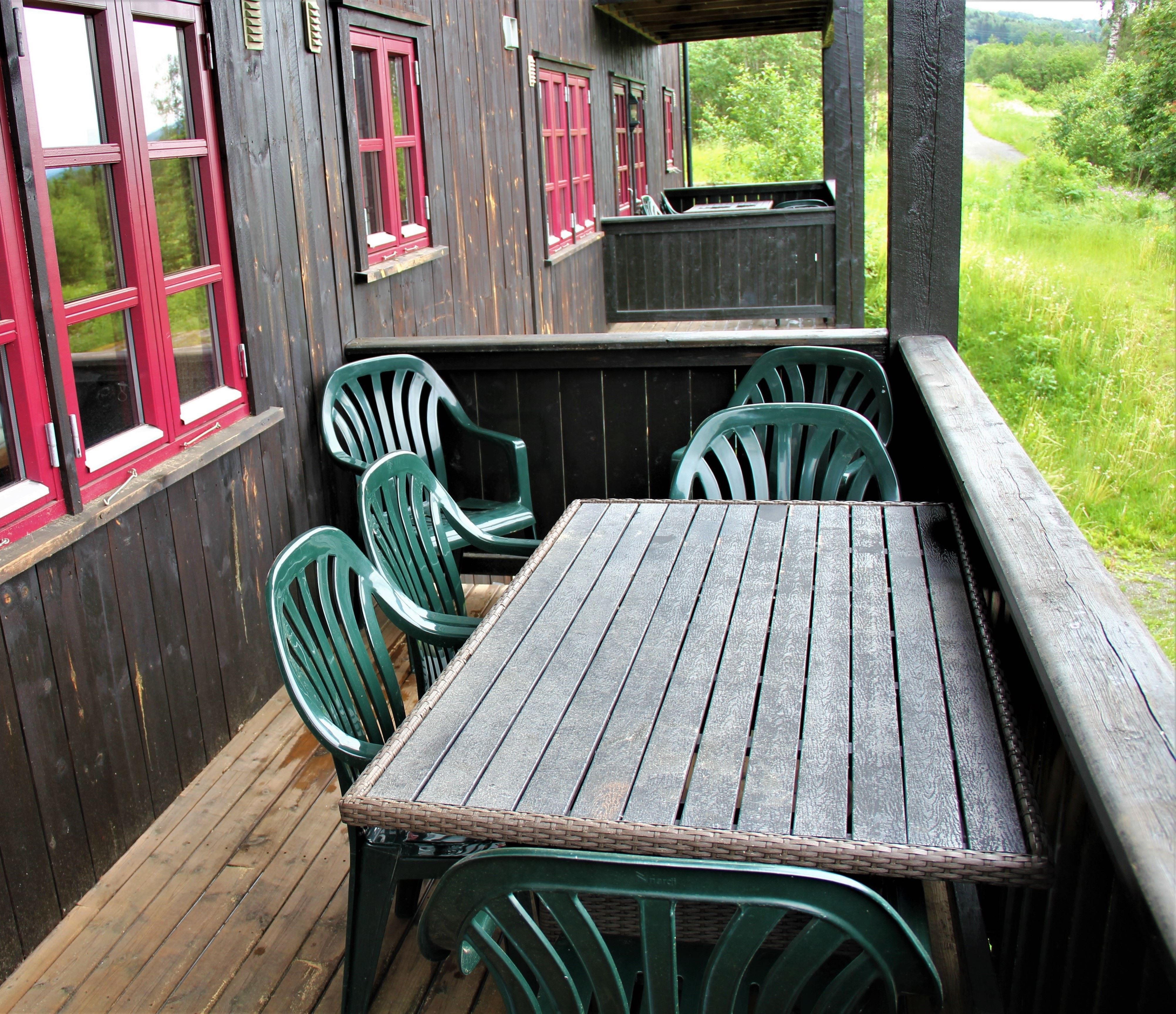 A table and chairs on a veranda.