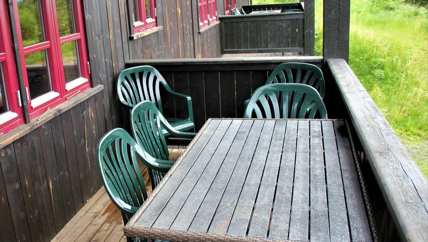 A table and chairs on a veranda.