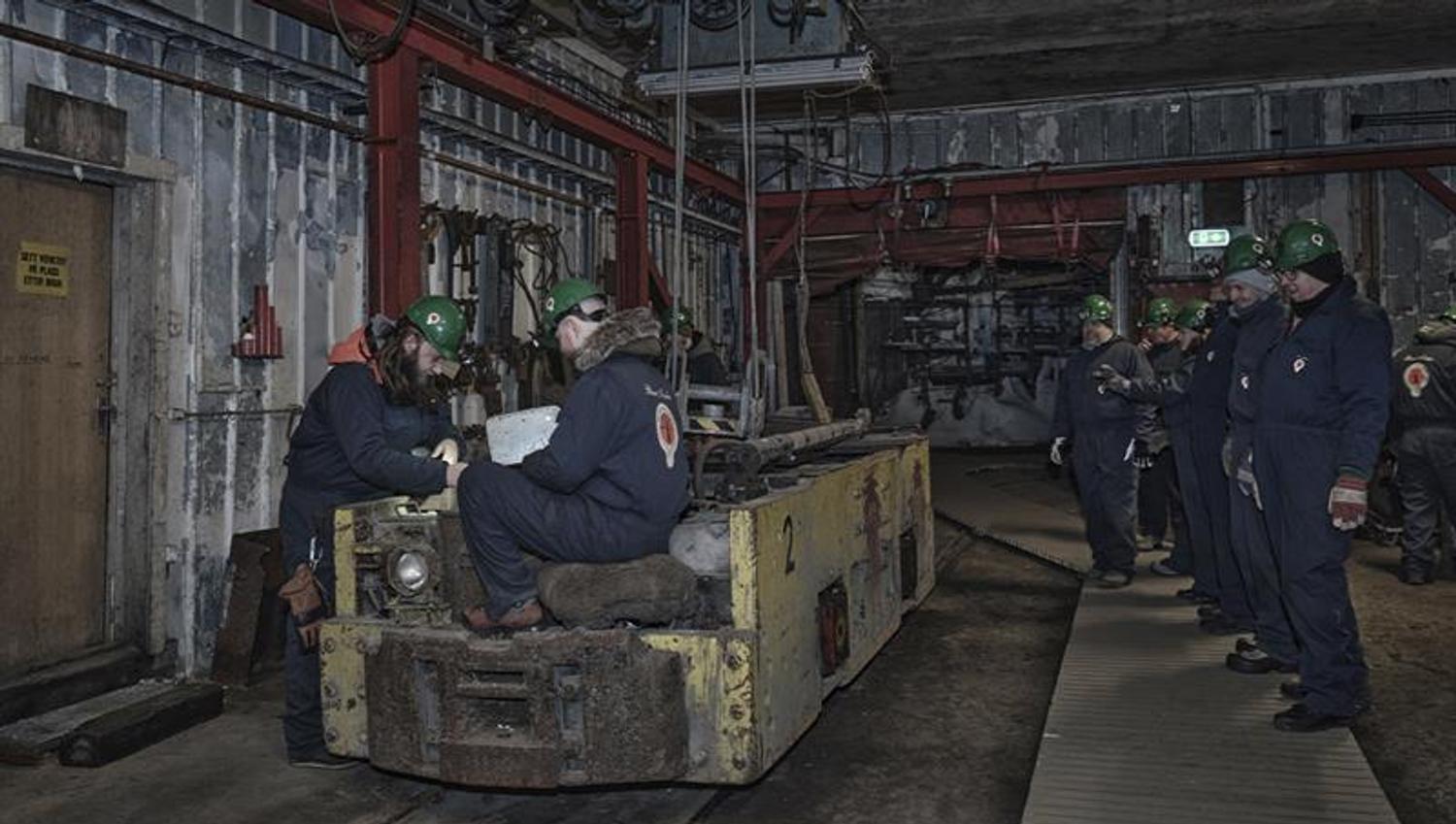 Guests on a guided tour of Mine 3 being shown around the mechanical workshop in the mine