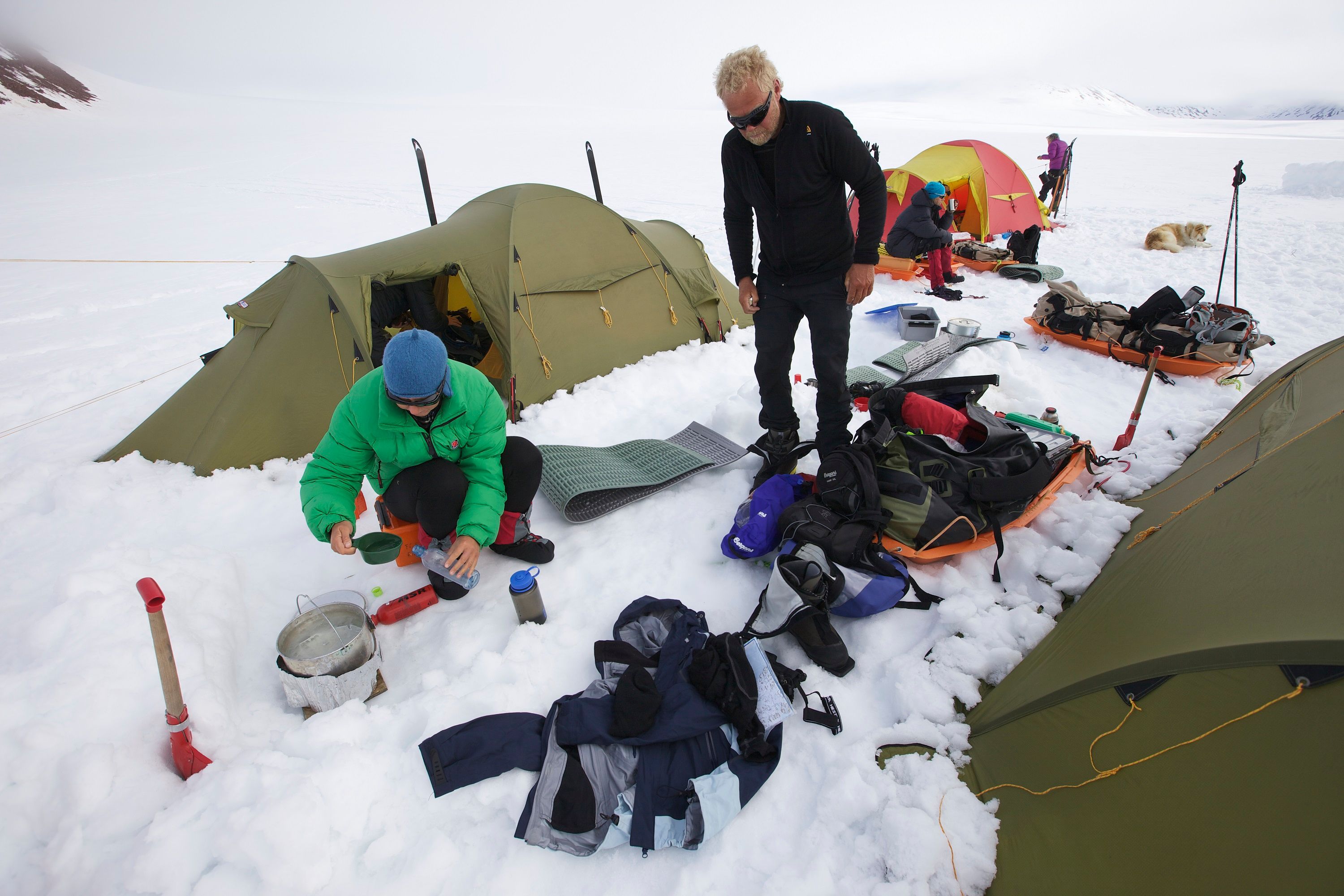 To personer som koker vann i en teltleir