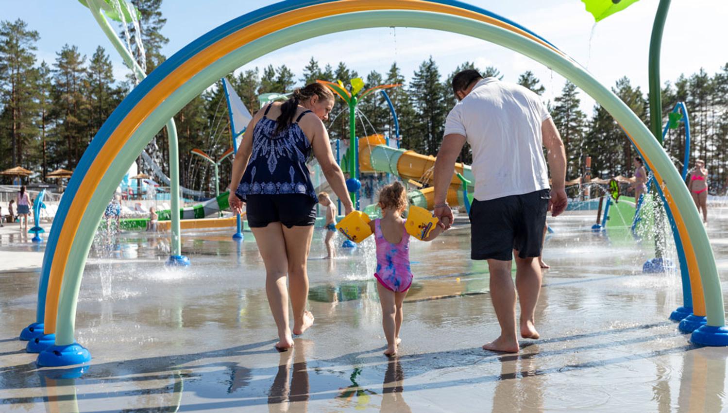 family with a small child in the splash park at Bø Sommarland