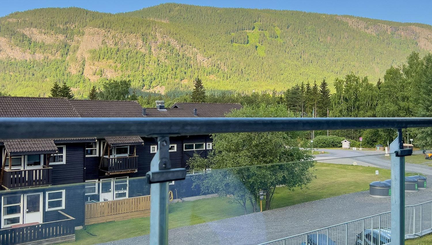 View of a road and a car from a balcony.