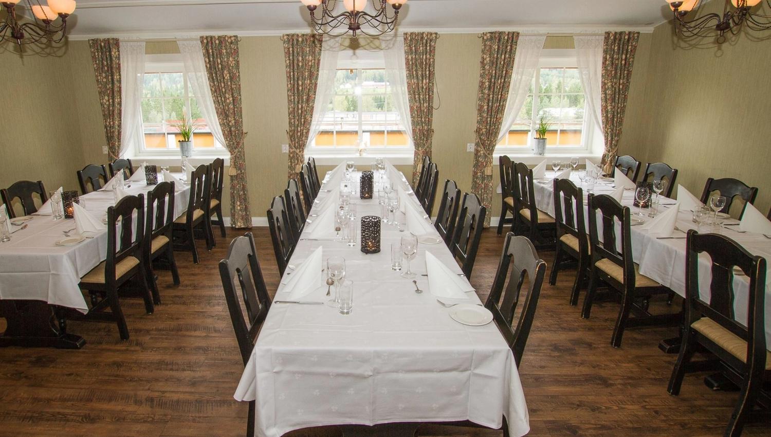 A room with a table and chairs.