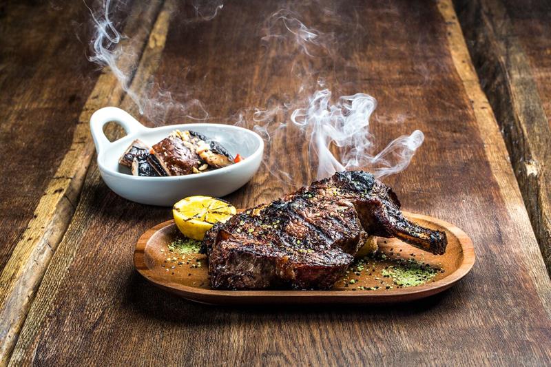 Detail photo of steak with side dish.