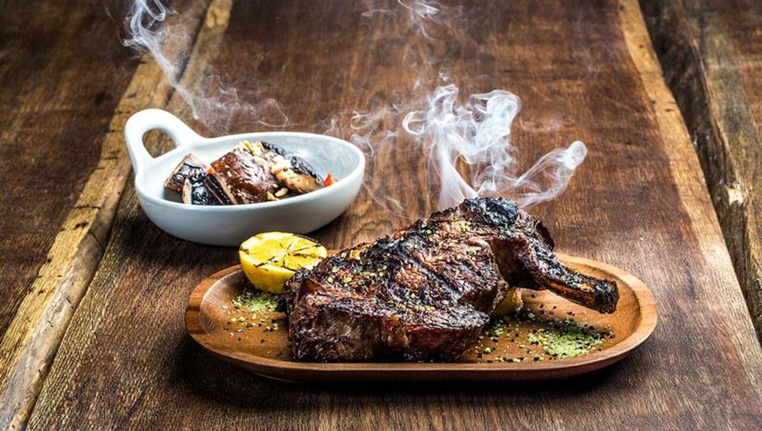 Detail photo of steak with side dish.