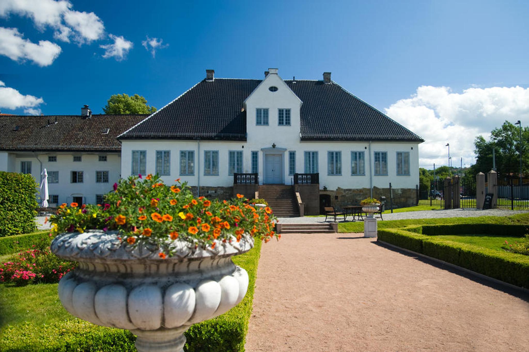 Exterior: White manor from the Baroque era with a lawn in front of it.