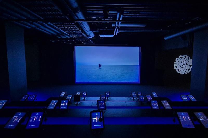 A big screen showing a film of a Viking ship at sea