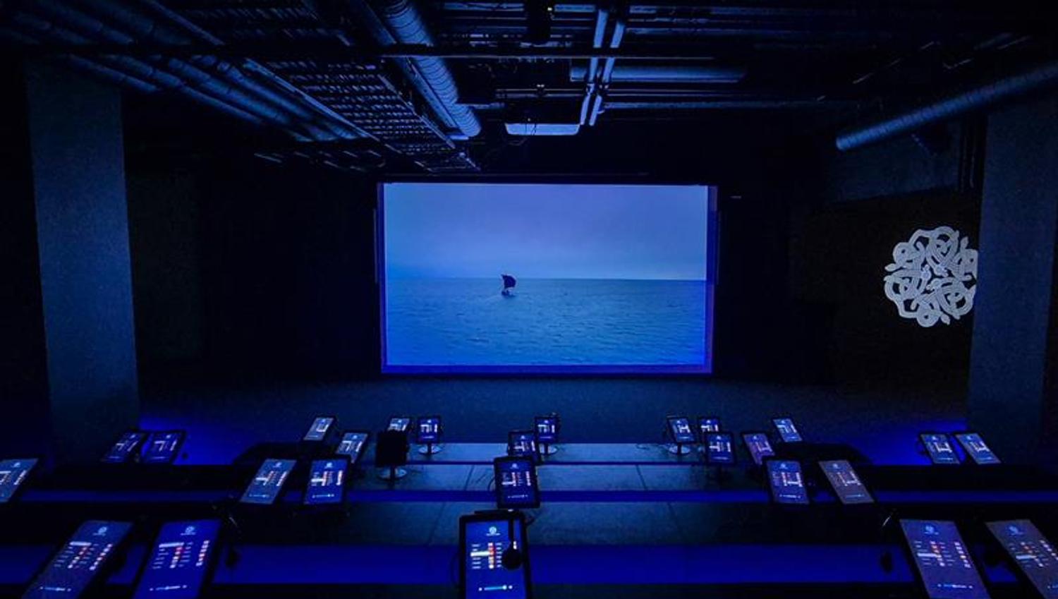 A big screen showing a film of a Viking ship at sea