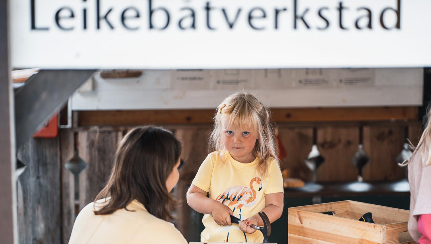 Children playing at the toy boat workshop at Hardanger Maritime Center.