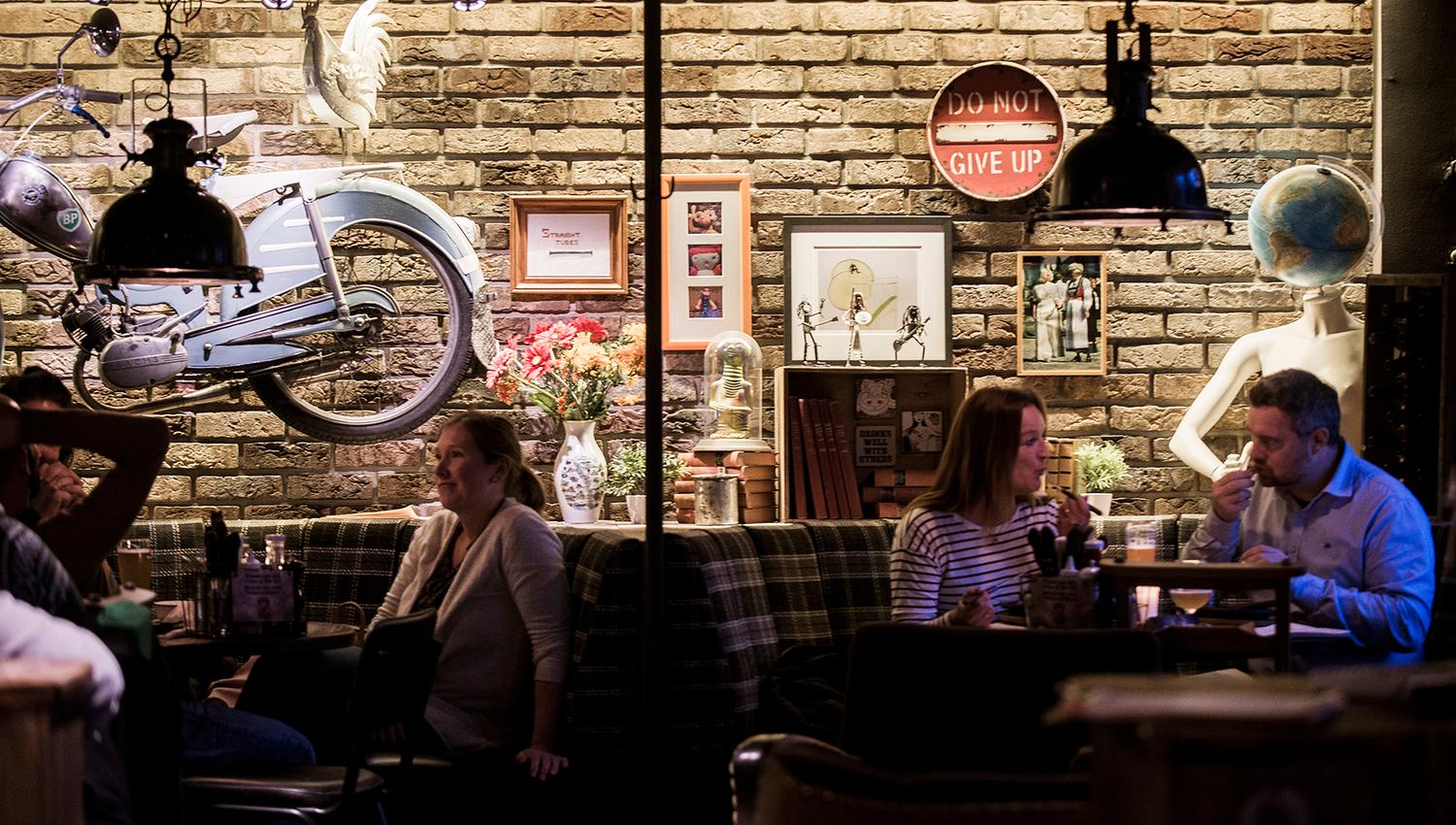 Guests enjoying dinner and drinks at Heim Gastropub