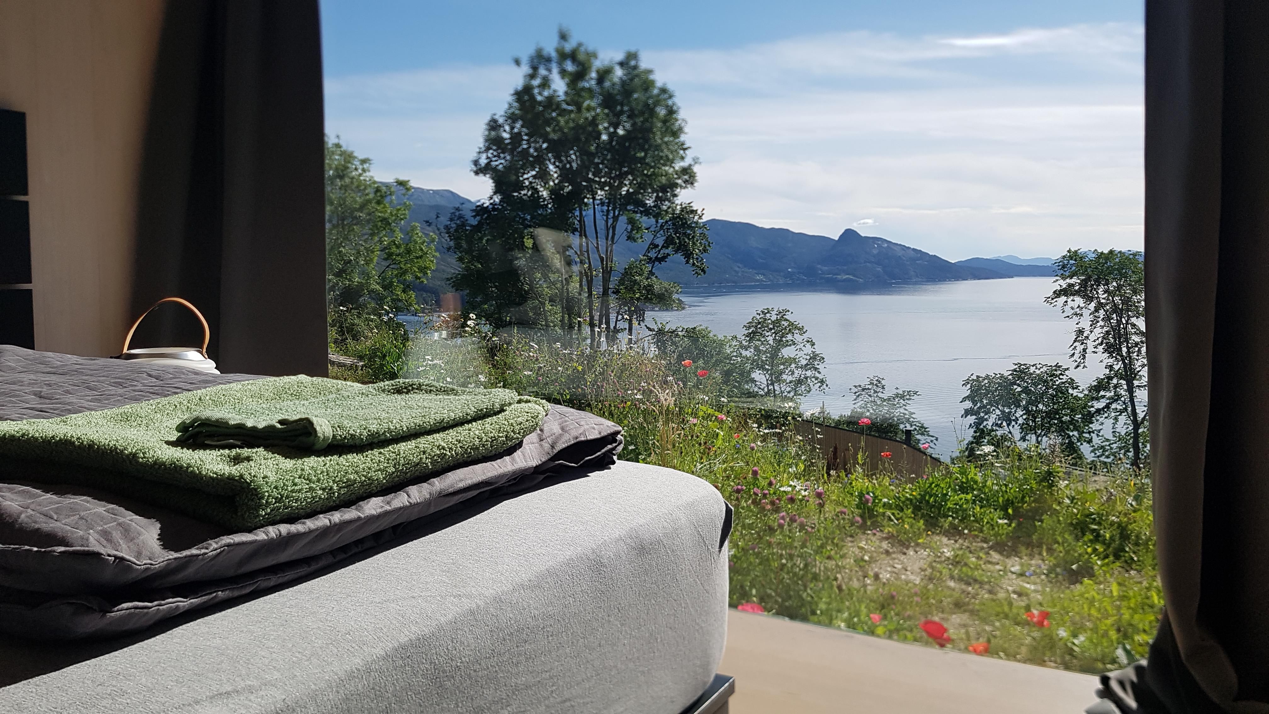Sleeping area with a view of Hardangerfjord, surrounded by nature.