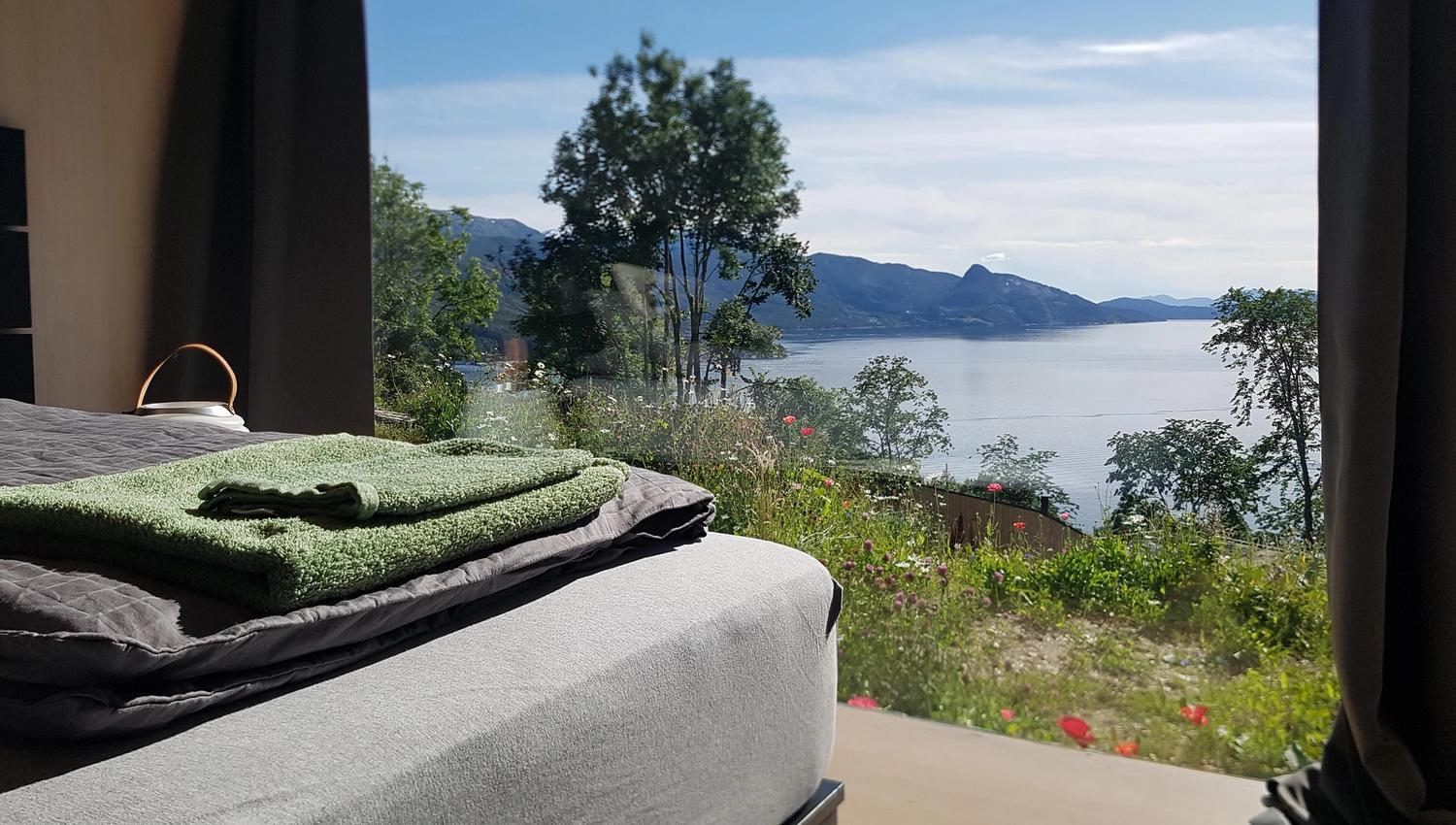 Sleeping area with a view of Hardangerfjord, surrounded by nature.