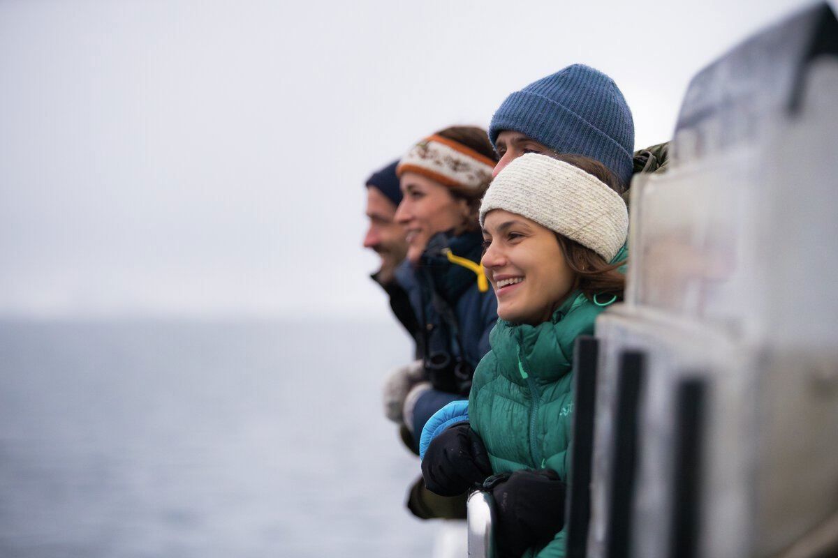 People enjoying the view on a whale watching tour with Rødne Fjord Cruise