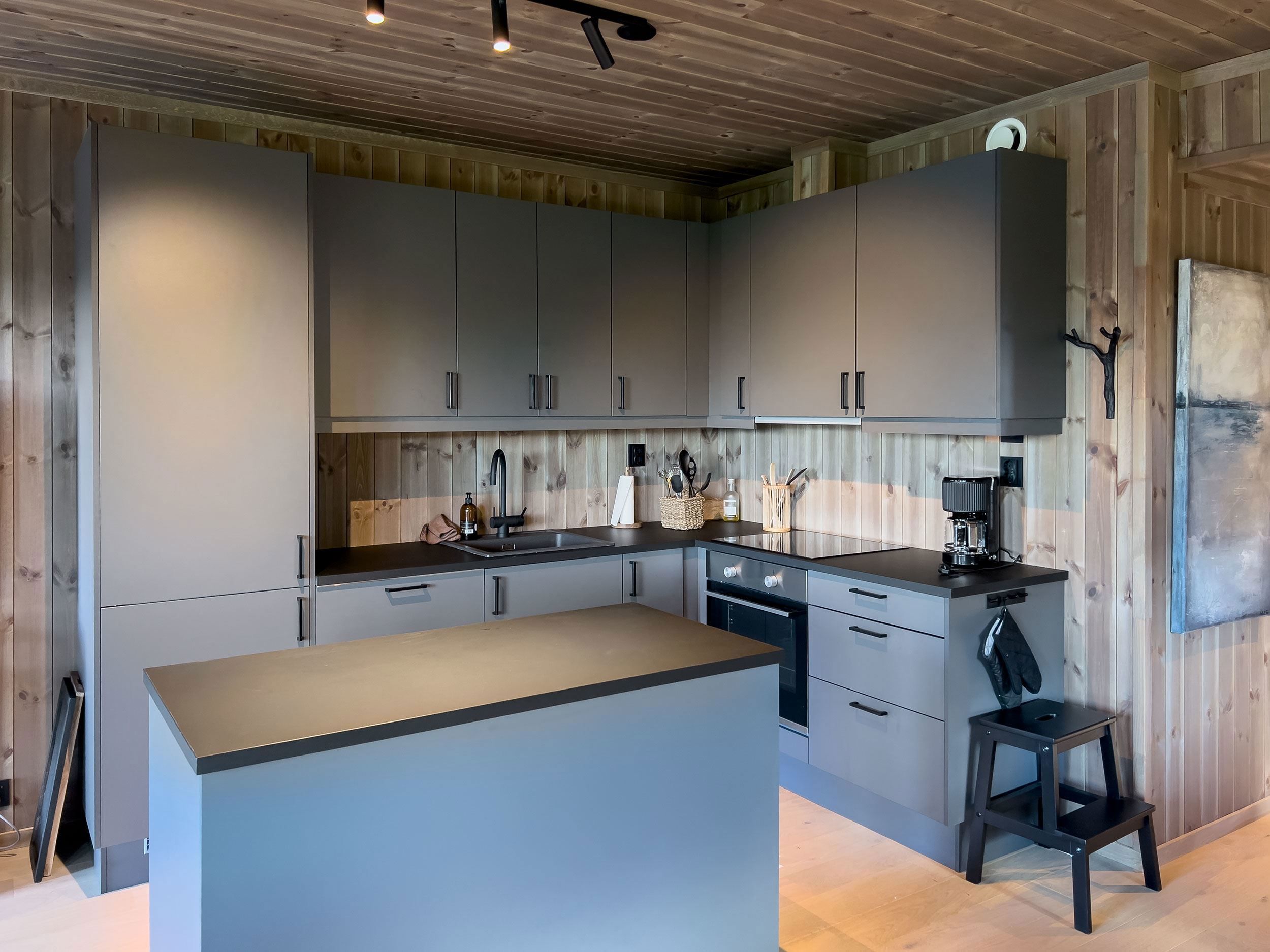 A kitchen with worktop and stool.
