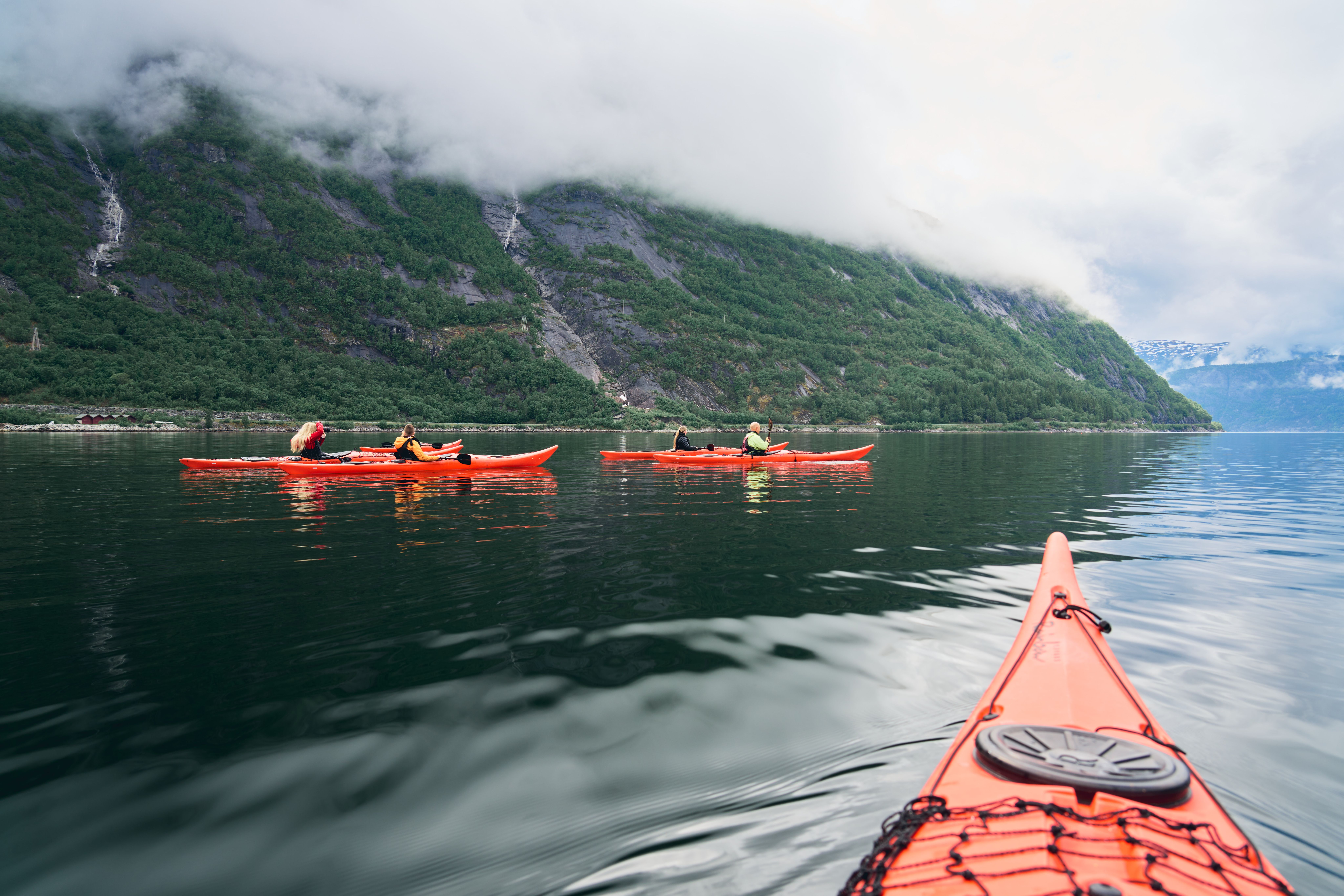A few red kayaks on the fjord.