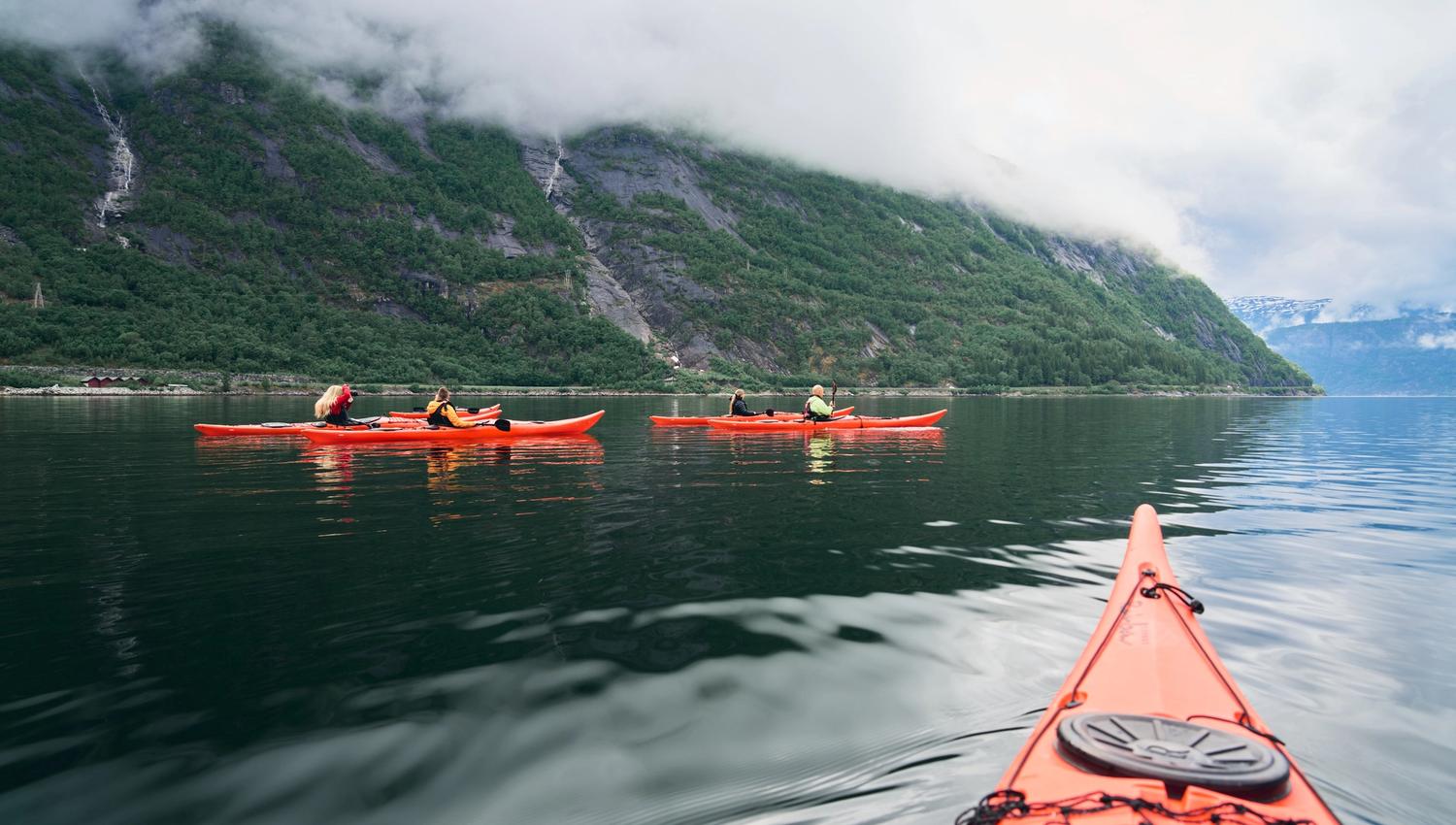 A few red kayaks on the fjord.