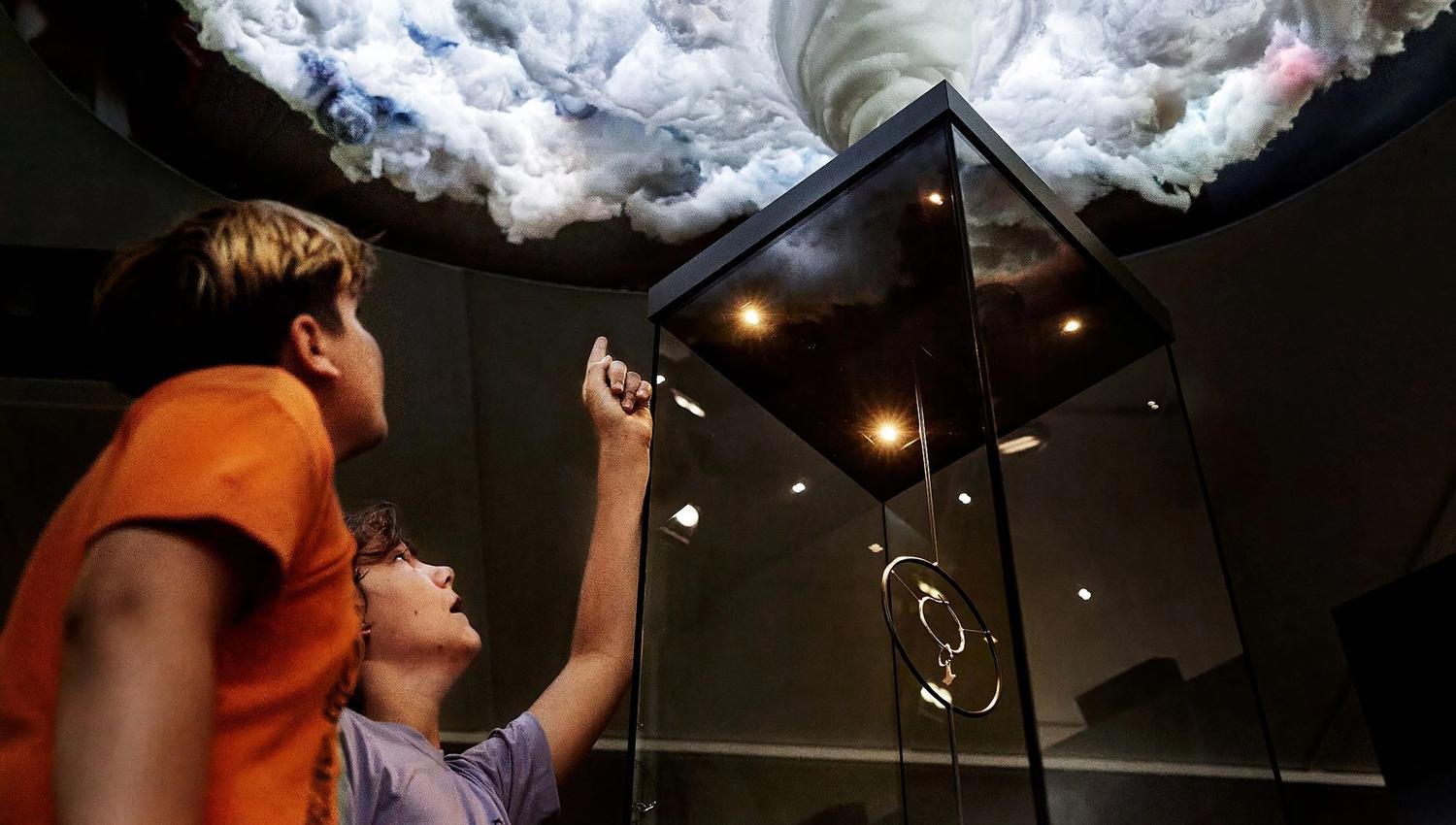 Two children lookign at an installation on display