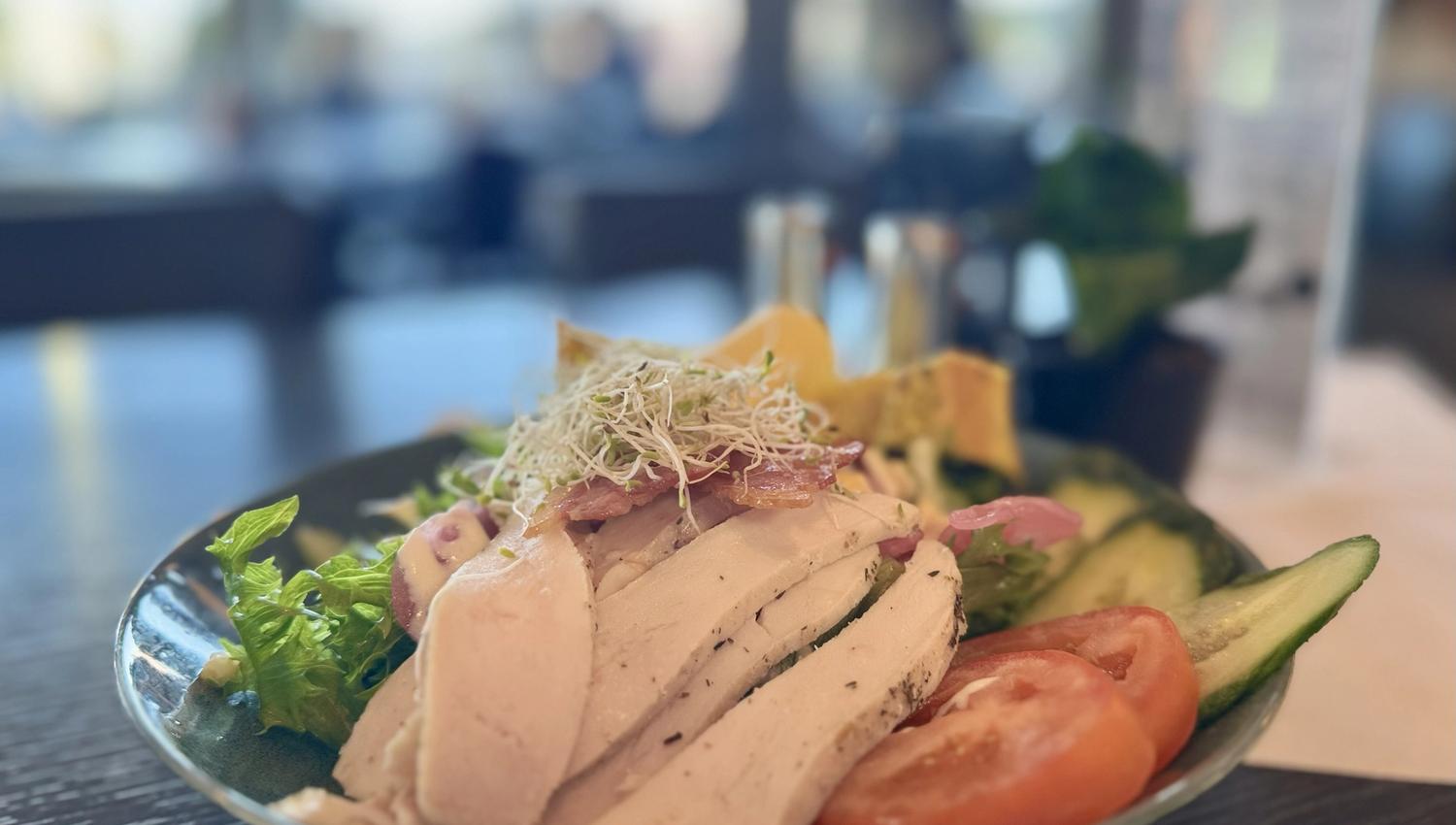 Chicken salad with cucumber, tomato, sprouts, and lots of delicious ingredients.